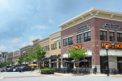 A pedestrian walks through Town Brookhaven, a mixed-use